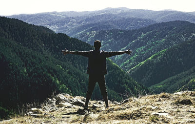 Rear view of man standing on mountain