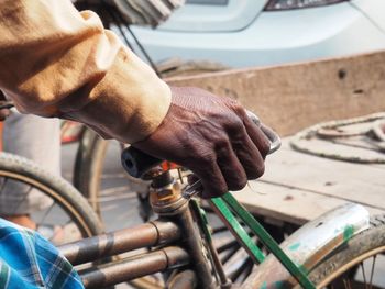 Cropped hand on bicycle