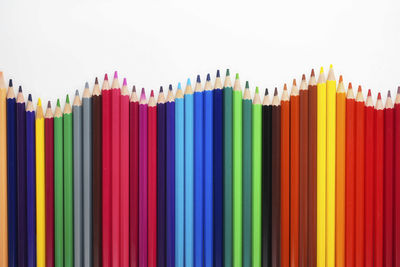 Close-up of colored pencils against white background