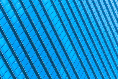 Low angle view of modern blue glass building