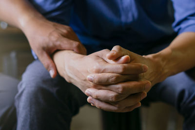 Midsection of man holding hands