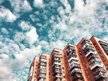 Low angle view of buildings against cloudy sky