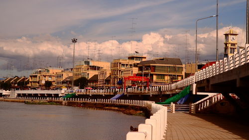 Bridge over river against buildings in city