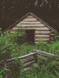 Abandoned built structure in forest against sky