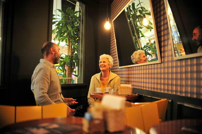 Woman sitting on table at restaurant