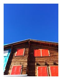 Low angle view of building against clear blue sky