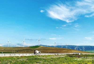 Windmill on field against sky