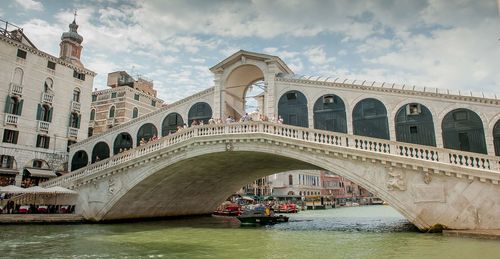 View of bridge over canal against cloudy sky