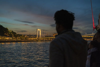 African male taking image of illuminated elisabeth bridge at night