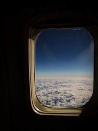 View of cloudy sky seen through airplane window