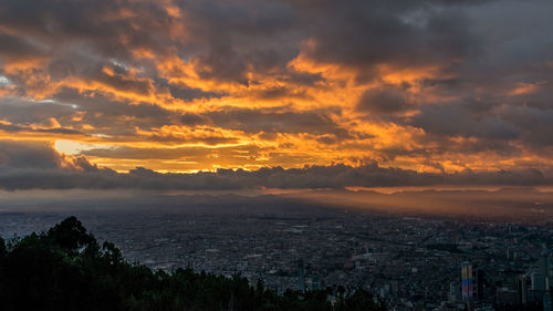 Scenic view of cityscape against sky during sunset