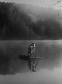 Diving platform in lake during foggy weather