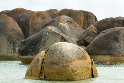 Rocks on beach against sky