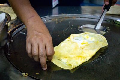 Midsection of person preparing food in kitchen