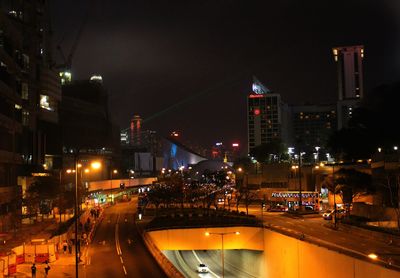 Illuminated city street and buildings at night