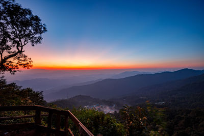 Scenic view of silhouette mountains against sky at sunset