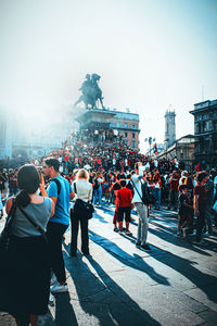 Rear view of people walking on street