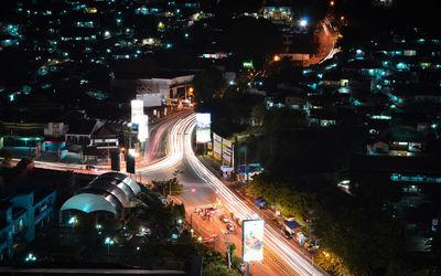 High angle view of illuminated city street and buildings at night