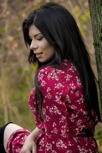 Side view of a smiling young woman