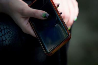 Close-up of person holding smart phone