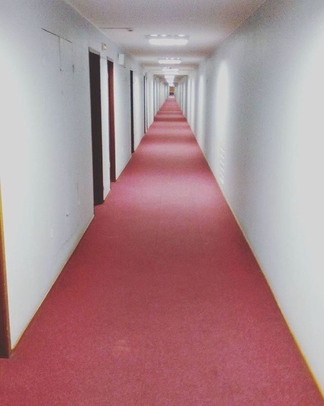 indoors, the way forward, diminishing perspective, corridor, vanishing point, empty, absence, illuminated, architecture, ceiling, in a row, built structure, lighting equipment, red, no people, narrow, flooring, wall - building feature, long, tiled floor