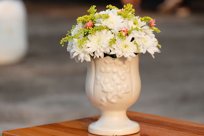 Close-up of white flower vase on table