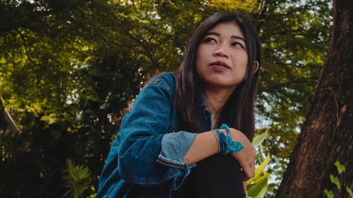 Portrait of a beautiful young woman in forest