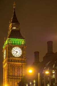 Low angle view of illuminated big ben against sky at night