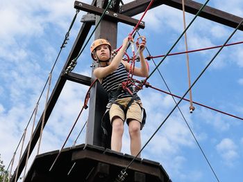 Low angle view of man standing against sky