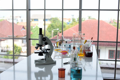 People on table seen through glass window