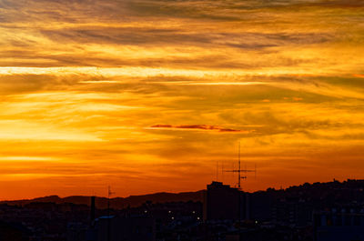 Silhouette of city during sunset