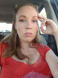 Portrait of beautiful young woman in car