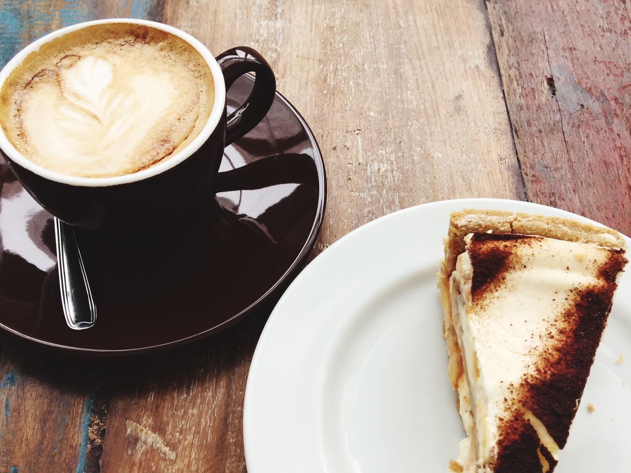 table, food and drink, drink, coffee - drink, coffee cup, still life, frothy drink, refreshment, freshness, high angle view, indulgence, cappuccino, saucer, indoors, plate, unhealthy eating, cup, froth art, food, latte, no people, ready-to-eat, temptation, sweet food, close-up, day