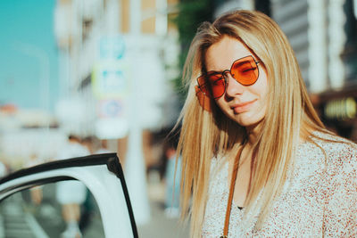 Portrait of young woman wearing sunglasses