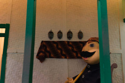 Close-up of toys against wall