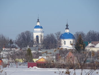 Buildings against clear sky during winter