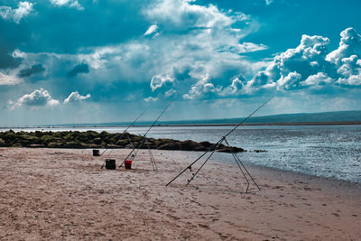 Fishing net on beach against sky