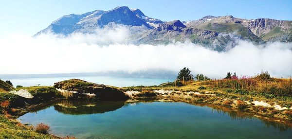 Scenic view of lake and mountains against sky