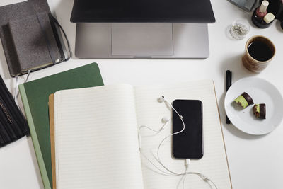 View of desk with diary and cell phone