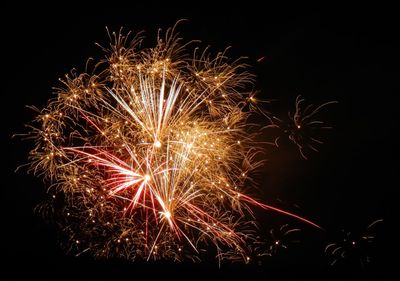 Low angle view of firework display at night