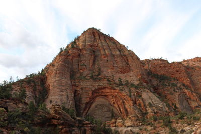 Low angle view of rock formation against sky