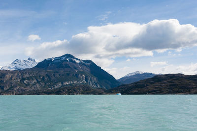 Scenic view of sea and mountains against sky