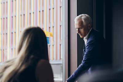 Confident mature manager planning strategy in board room during meeting at creative office