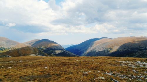 Scenic view of mountains against cloudy sky