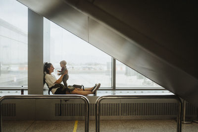 Mother with baby waiting at airport