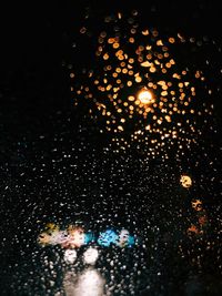 Low angle view of raindrops on glass