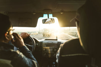 Rear view of people sitting in car