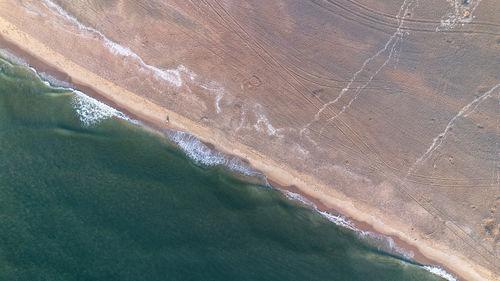 Beautiful flight in summer over the beach in katwijk aan zee. people are resting near the sea.