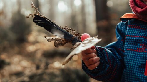 Close-up of woman playing with bird