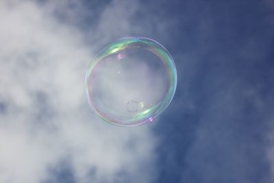 Close-up of bubbles against rainbow in sky